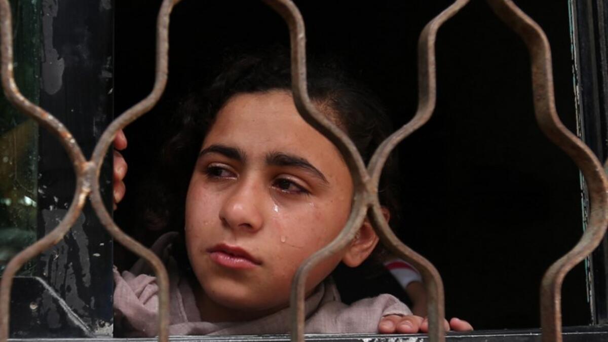A Relative of 19-year-old Palestinian Anas Abu Aser, who died a week after being shot by Israeli soldiers during protests on the Gaza-Israel border, cries during his funeral in Gaza City on May 3, 2018. (MOHAMMED ABED / AFP)