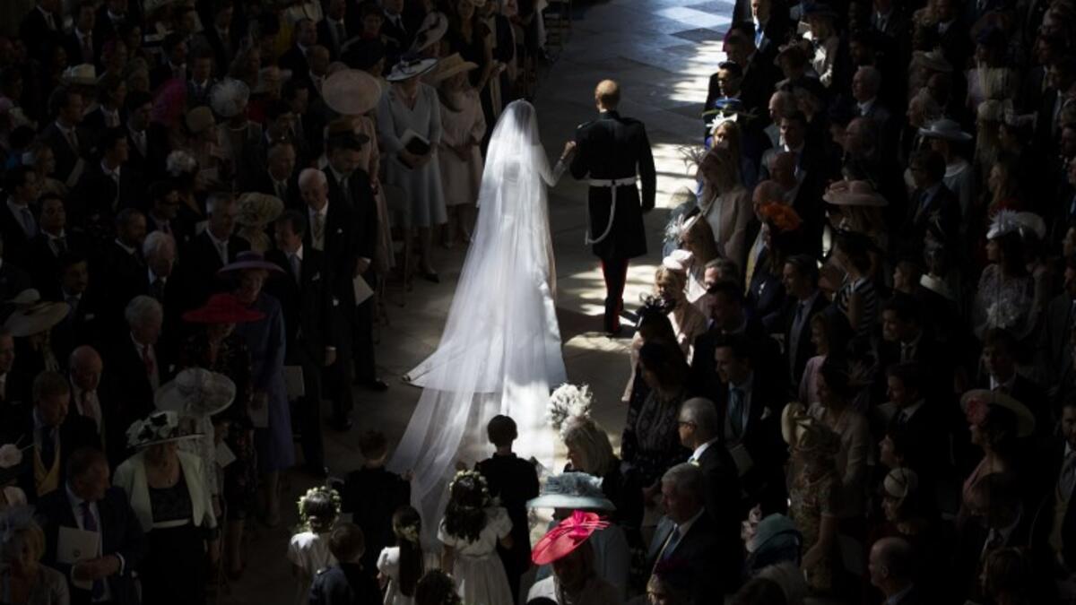 Britain's Prince Harry, Duke of Sussex (R) and Britain's Meghan Markle, Duchess of Sussex, (L) walk away from the High Altar toward the West Door at the end of their wedding ceremony in St George's Chapel, Windsor Castle, in Windsor, on May 19, 2018. 
Danny Lawson/ AFP