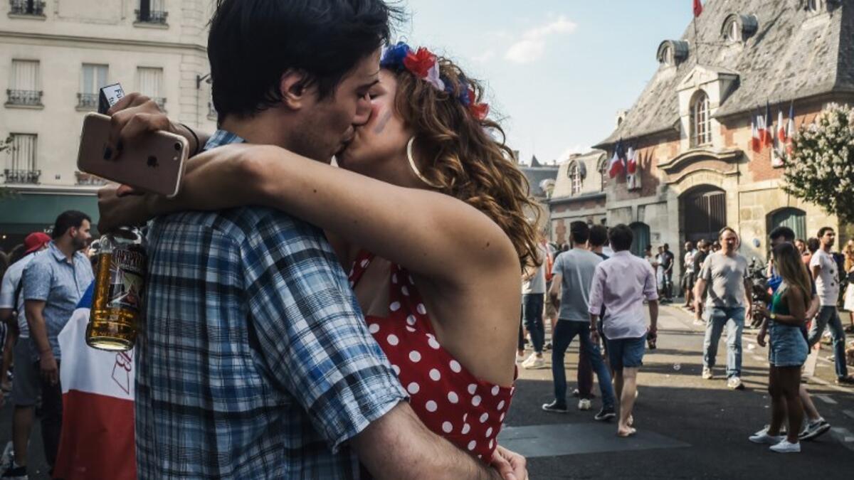 A couple kiss as they celebrate after France won the Russia 2018 World Cup final football match between France and Croatia, outside the "Le Carillon" bar in Paris on July 15, 2018, where the attacks of November 2015 took place.
Lucas BARIOULET / AFP