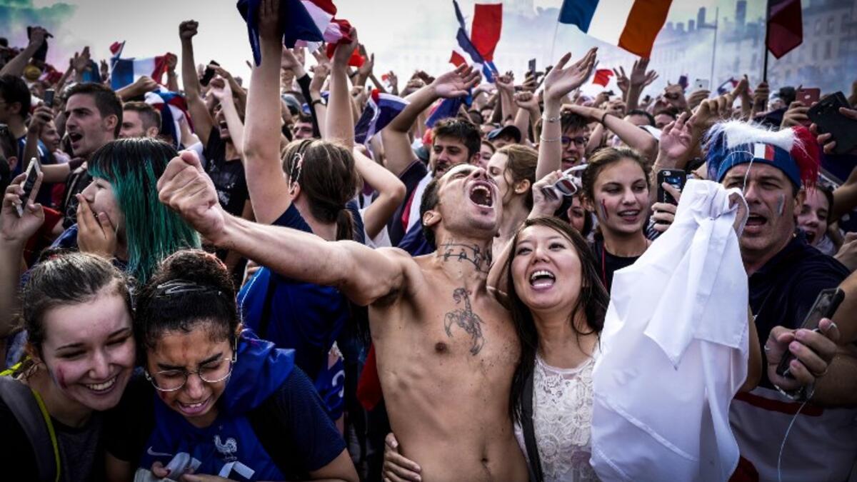 France supporters celebrate in Lyon on July 15, 2018, after France won the Russia 2018 World Cup final football match between France and Croatia. 
JEAN-PHILIPPE KSIAZEK / AFP