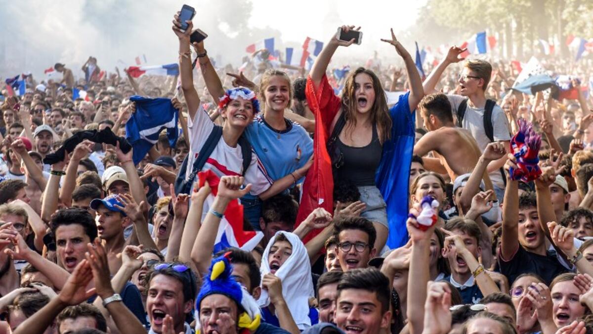 People celebrate on the Place de la Republique (Republic's Square) in Paris on July 15, 2018, after France won the Russia 2018 World Cup final football match between France and Croatia. 
Lucas BARIOULET / AFP
