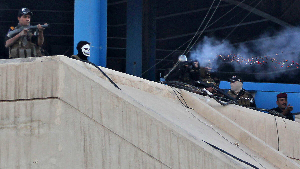 Iraqi security forces fire tear gas toward protesters during a demonstration against unemployment and a lack of basic services in the capital Baghdad's Tahrir Square on July 20, 2018. (AFP/ Ahmad Al Rubaye)