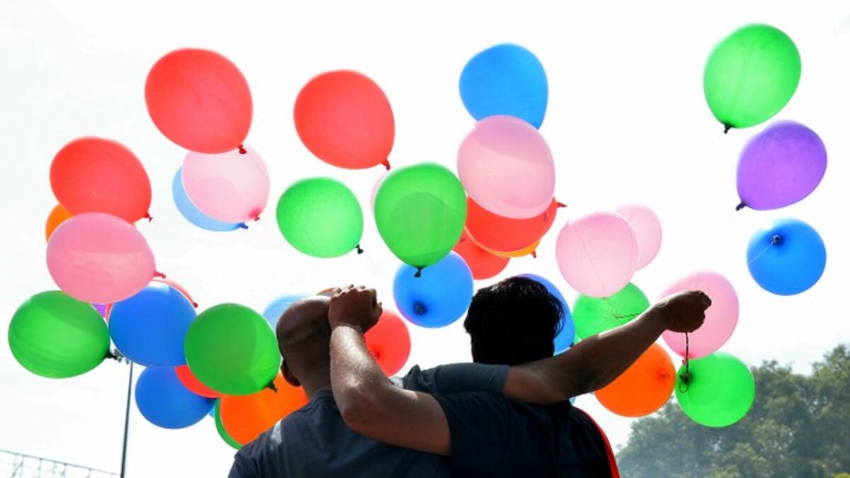 Indian members and supporters of the lesbian, gay, bisexual, transgender (LGBT) community celebrate the Supreme Court decision to strike down a colonial-era ban on gay sex, in Bangalore on September 6, 2018. 
MANJUNATH KIRAN / AFP