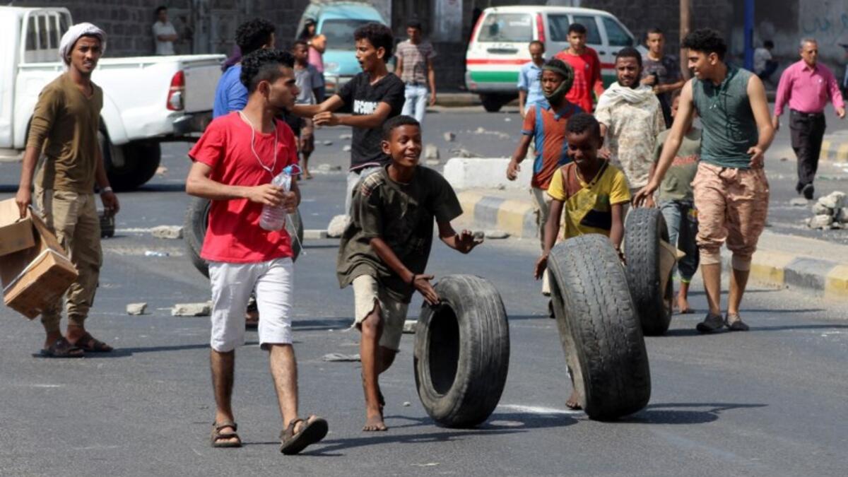Yemeni children push tyres in Crater, on September 6, 2018
Saleh Al-OBEIDI / AFP