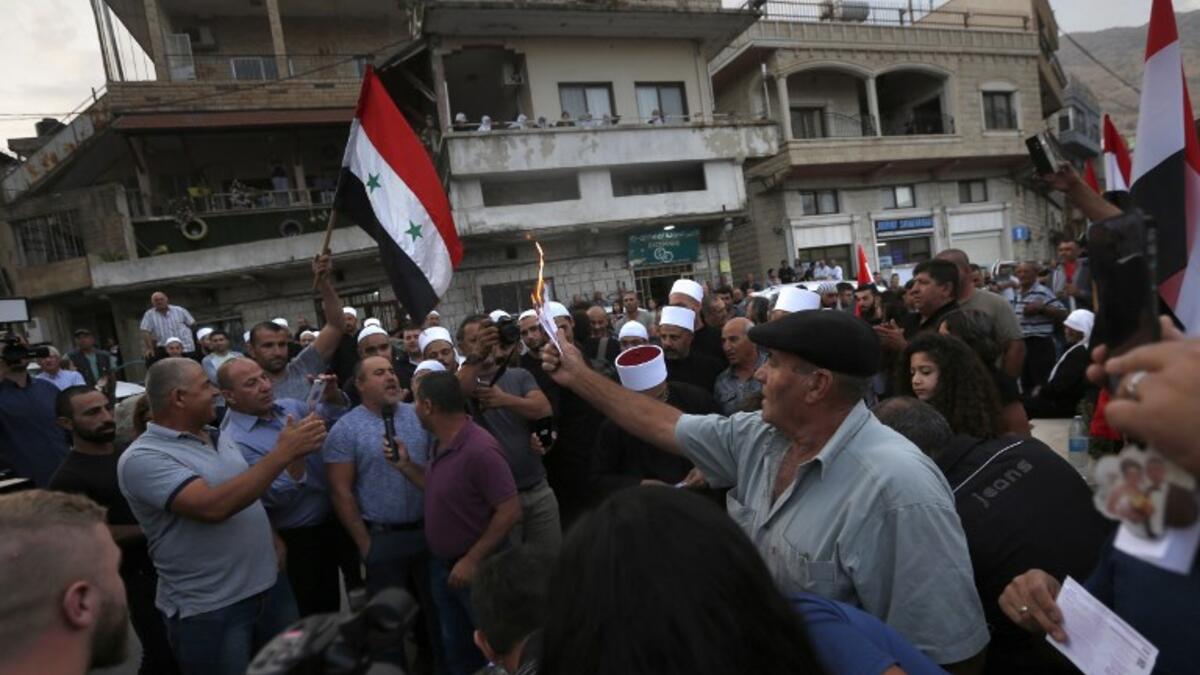 Druze residents of Majdal Shams in the Israeli-annexed Golan Heights set ablaze makeshift ballot papers during a protest. (JALAA MAREY / AFP)