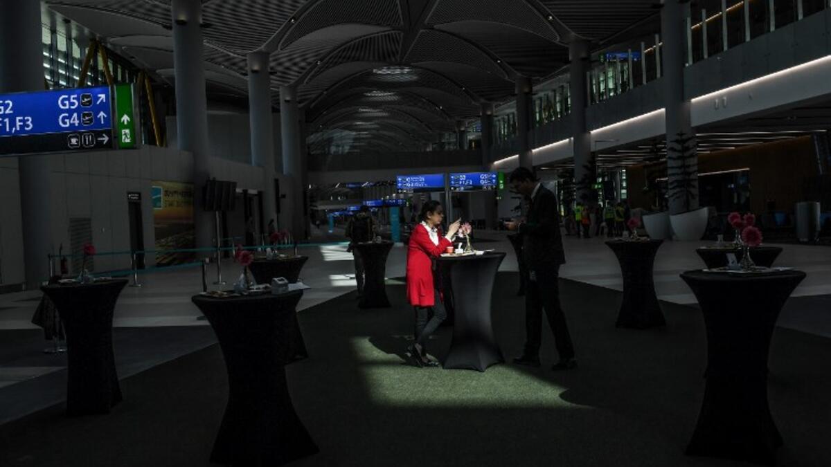 Visitors are seen taking a break in the new airport building during a press tour of Istanbul's third airport, the Istanbul New Airport, in the Arnavutkoy district on the European side of Istanbul on October 25, 2018. 
BULENT KILIC / AFP