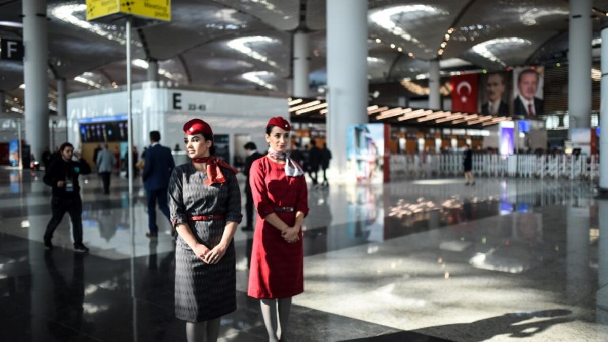 Air hostesses walk during the opening ceremony of Istanbul's third airport, the Istanbul New Airport, in the Arnavutkoy district on the European side of Istanbul on October 29, 2018. 
BULENT KILIC / AFP