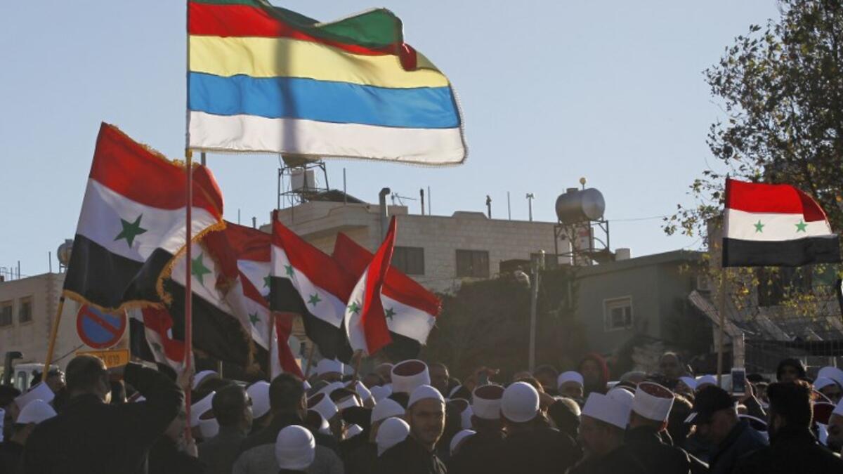 Druze men protest against municipal elections in front of a polling centre in the village of Majdal Shams in the Israeli-annexed Golan Heights on October 30, 2018. (JALAA MAREY / AFP)
