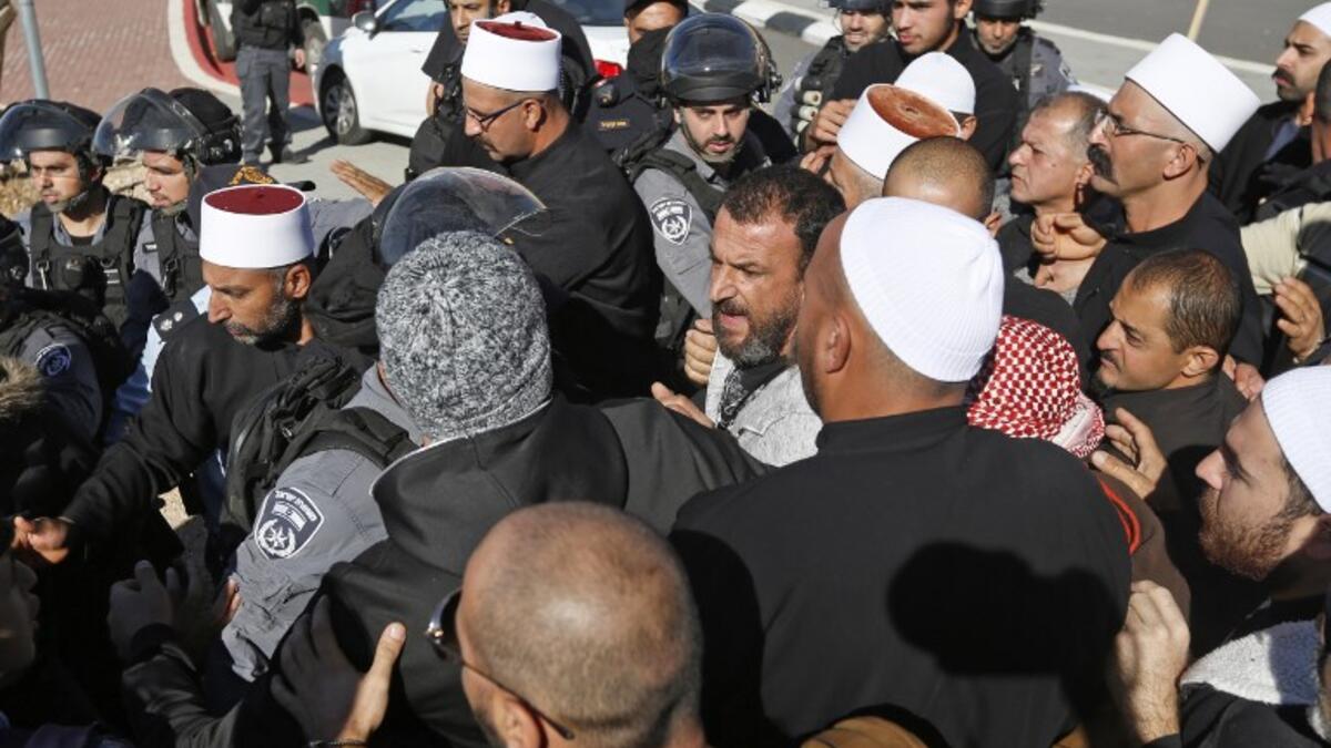 Israeli security forces stand guard as Druze men protest against municipal elections. (JALAA MAREY / AFP)