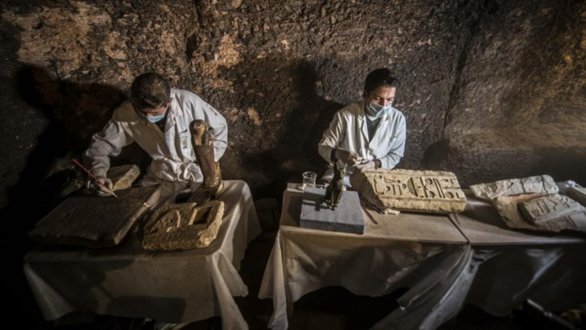 Egyptian archaeologist work on monuments during a new discovery made by an Egyptian archaeological mission. (KHALED DESOUKI / AFP)