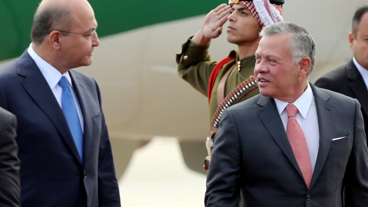 Jordan's King Abdullah II (R) greets Iraq's President Barham Salih at Amman's military airport, on November 15, 2018. 
Khalil MAZRAAWI / AFP