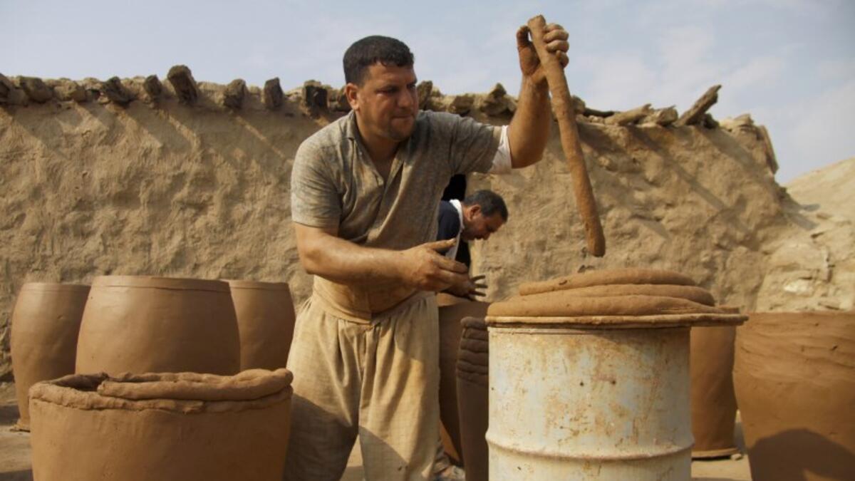 Iraqis making clay pots in Najaf on November 11, 2018. Pottery has deep roots in Iraq, where ancient civilisations turned to clay to build their homes, shape their cooking utensils, and even make their ovens.
Haidar HAMDANI / AFP