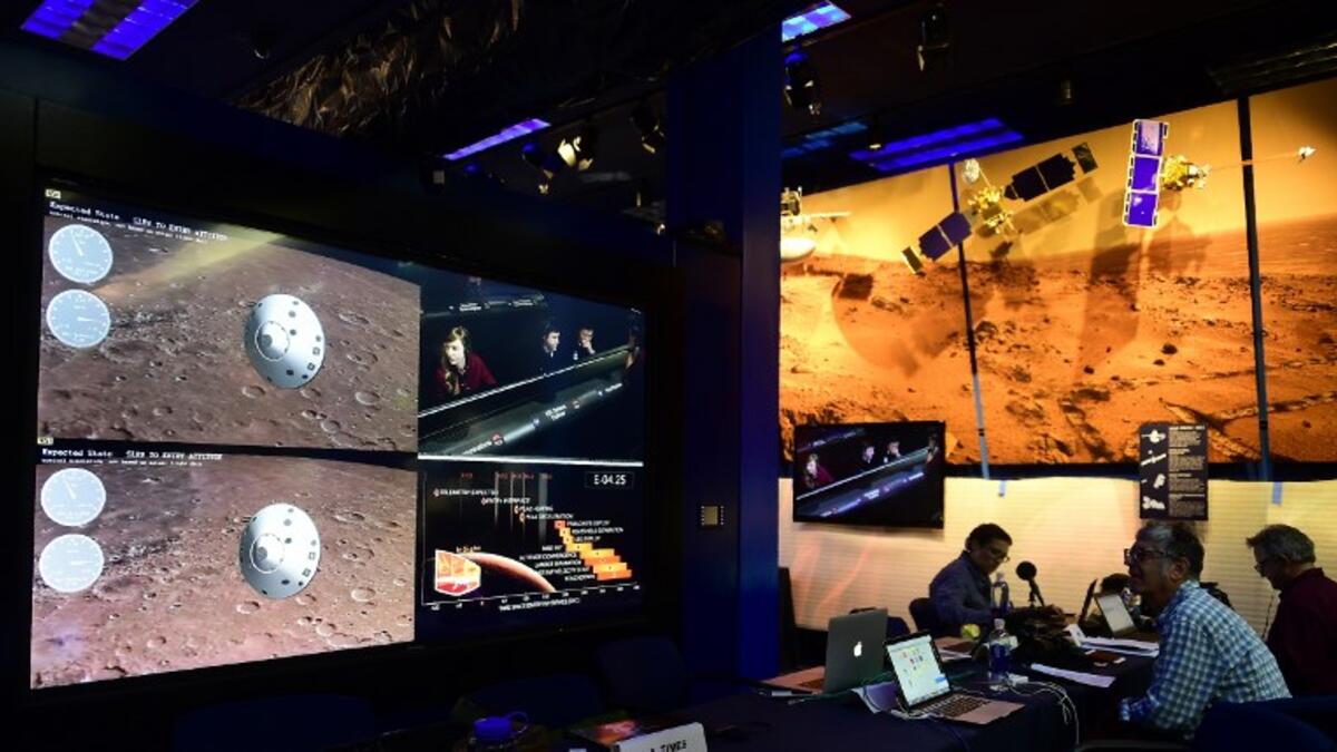 People watch the landing of NASA's InSight spacecraft on the planet Mars on television screens at NASA's Jet Propulsion Laboratory (JPL) in Pasadena, California on November 26, 2018.
Frederic J. BROWN / AFP
