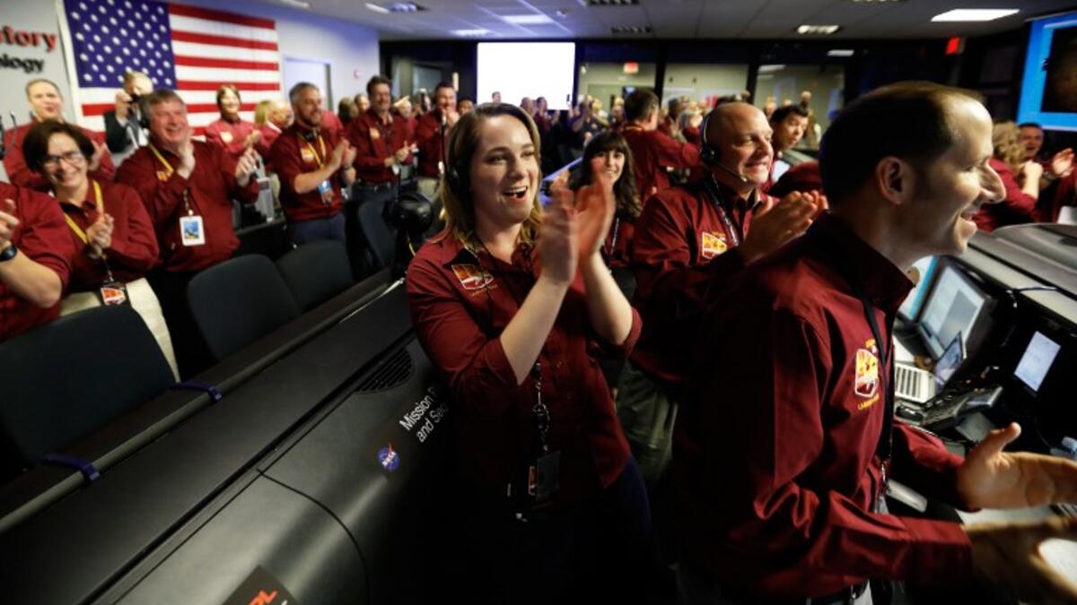 NASA engineers react after the successful landing by the InSight spacecraft on the planet Mars from California. 
Al SEIB / POOL / AFP