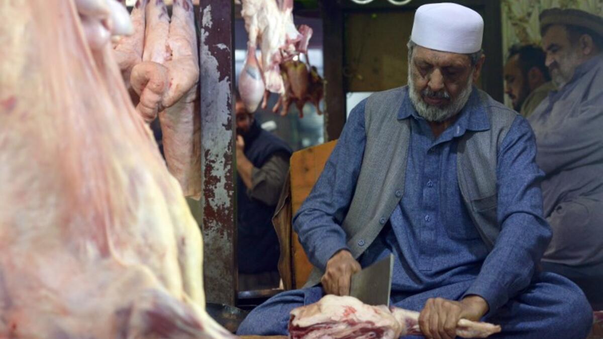 Pakistani butcher Nisar Charsi prepares meat in his restaurant in Namak Mandi in Peshawar.
ABDUL MAJEED / AFP