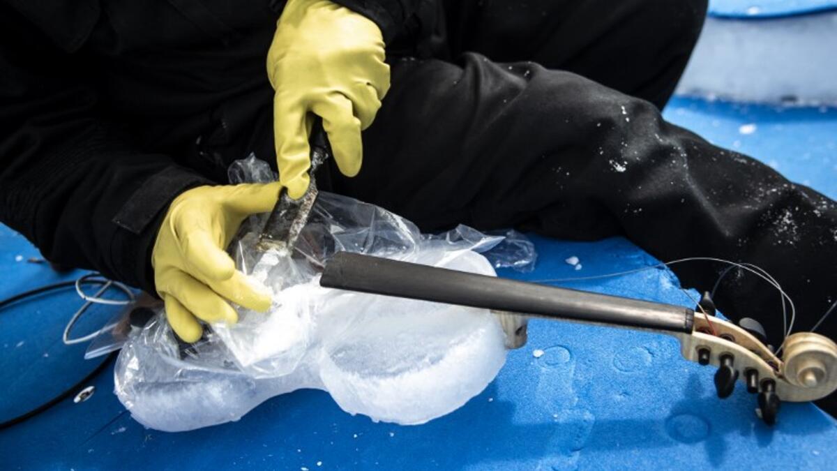 US artist Tim Linhart works on an ice violin in the "Ice Dome" on Presena Galcier, Tonale Pass, near Trento in northern Italy on January 18, 2018. 
MARCO BERTORELLO / AFP