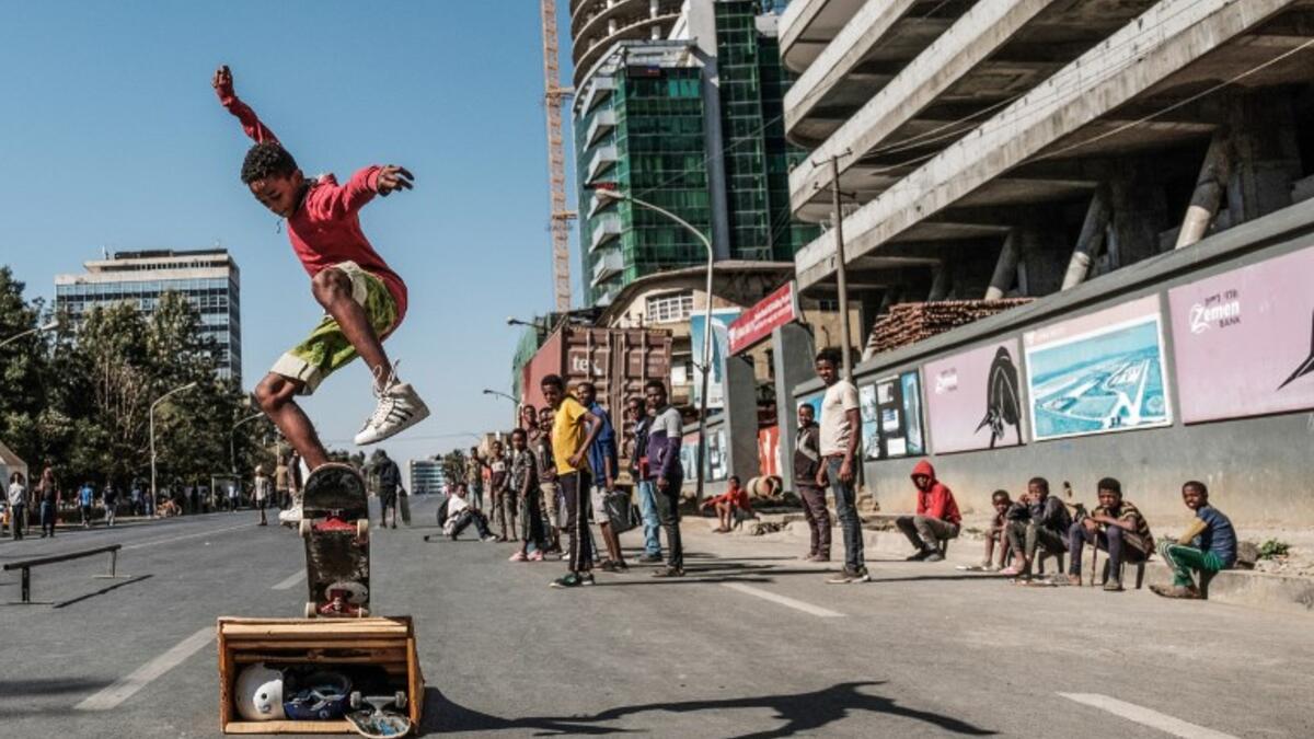 A skateboarder perfoms on a street in Addis Ababaon February 3, 2019 during the third Car Free Day promoted by local NGOs and the Ethiopian Government to appeal a healthy life style and a less air pollution of the capital city. 
EDUARDO SOTERAS / AFP