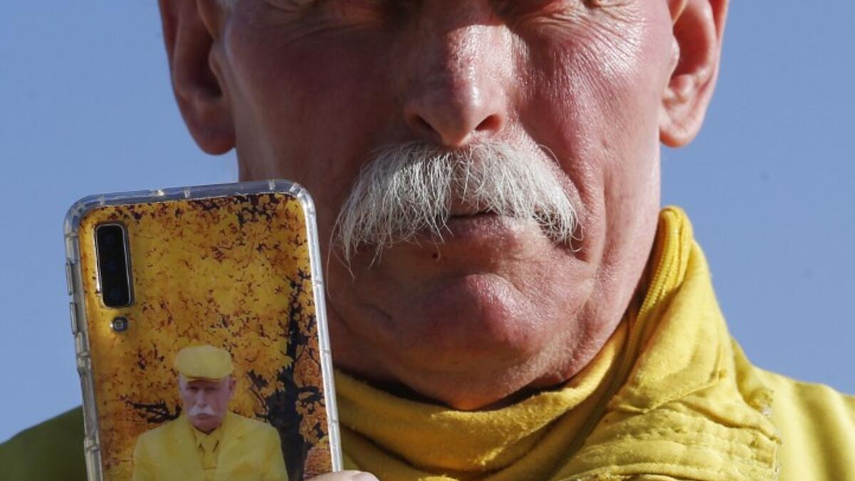 Abu Zakkour, Aleppo's so-called 'yellow man' shows his mobile telephone in the northern Syrian city on February 11, 2019. 
LOUAI BESHARA / AFP