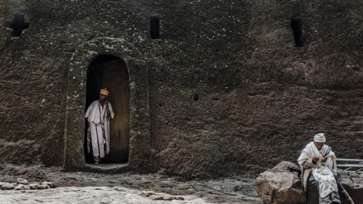 An Ethiopian Orthodox priest steps out of a room of the rock-hewn church of the House of the Saviour of the World in Lalibela, Ethiopia 
EDUARDO SOTERAS / AFP