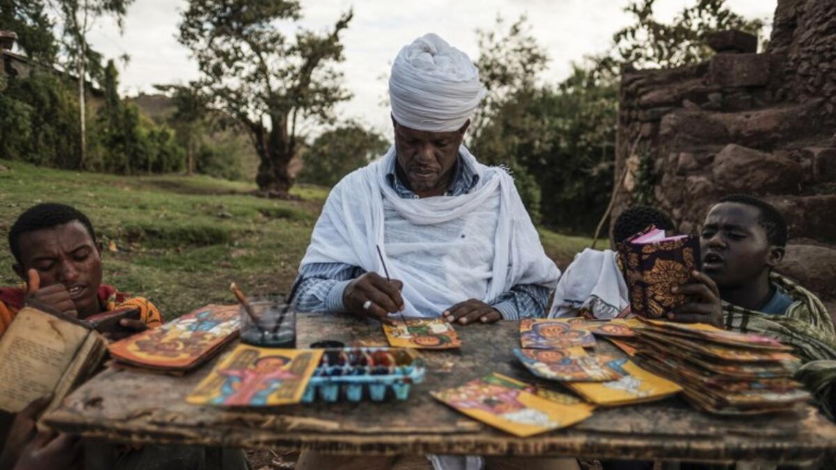 An Ethiopian Orthodox artist paints postcards in Lalibela, Ethiopia
EDUARDO SOTERAS / AFP