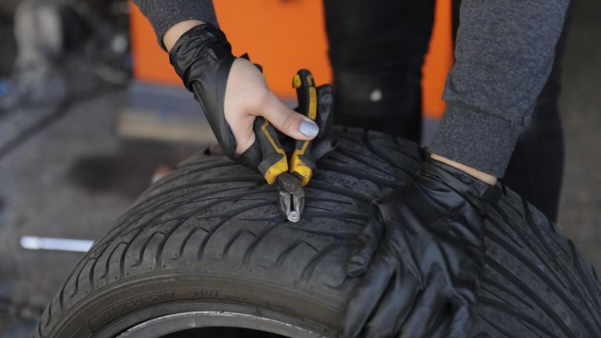 Amina repairs a flat tyre at a car tyre's repair shop in Beirut on March 8, 2019. Amina has been working for 10 years in mechanics, specially in the tyres repair business. She considers it fulfilling as she always dreamt of doing that job.
JOSEPH EID / AFP