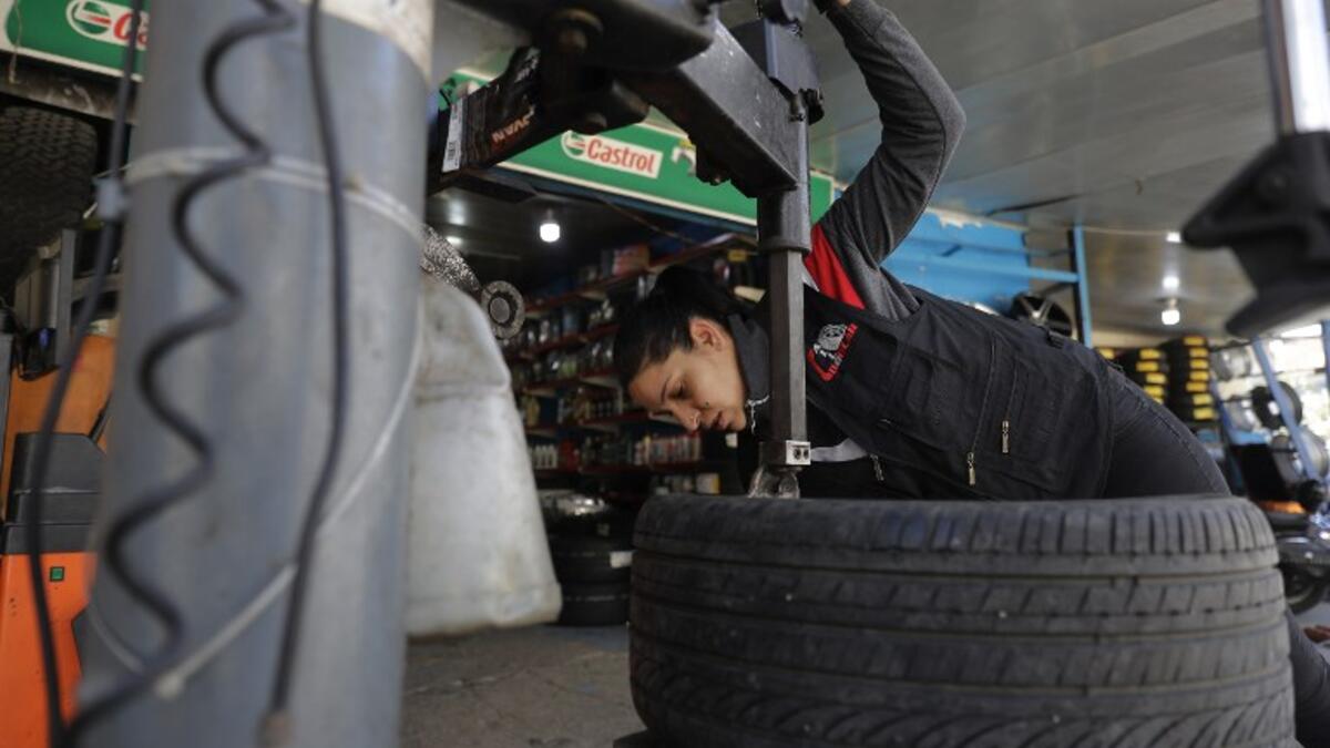 Amina repairs a flat tyre at a car tyre's repair shop in Beirut on March 8, 2019. Amina has been working for 10 years in mechanics, specially in the tyres repair business. She considers it fulfilling as she always dreamt of doing that job.
JOSEPH EID / AFP