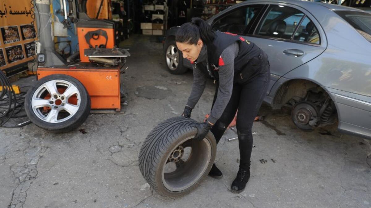 Amina repairs a flat tyre at a car tyre's repair shop in Beirut on March 8, 2019. Amina has been working for 10 years in mechanics, specially in the tyres repair business. She considers it fulfilling as she always dreamt of doing that job.
JOSEPH EID / AFP