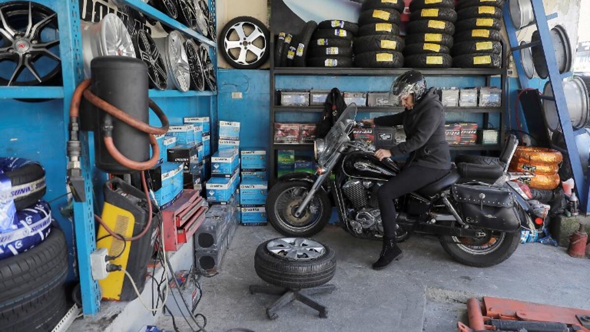 Amina repairs a motorbike's flat tyre at a tyre's repair shop in Beirut on March 8, 2019. Amina has been working for ten years in mechanics, specially in the tyres repair business. She considers it fulfilling as she always dreamt of doing that job.
JOSEPH EID / AFP