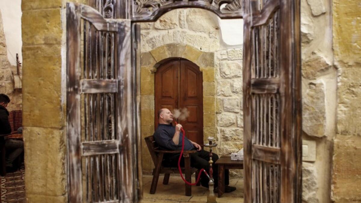 A man smokes a waterpipe (shisha or hookah) at the premises of the first traditional Turkish bath (Hammam) opening in the occupied Palestinian West Bank city of Hebron on March 11, 2019.
HAZEM BADER / AFP