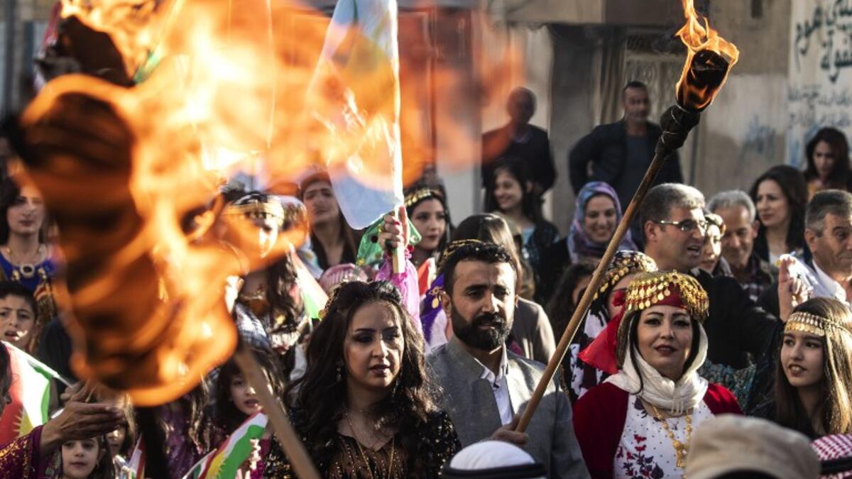 Kurds dressed in traditional outfits carry fire torches as they celebrate Nowruz (Noruz) in the Kurdish-controlled city of Qamishly in northeastern Syria on March 20, 2019.
Delil SOULEIMAN / AFP