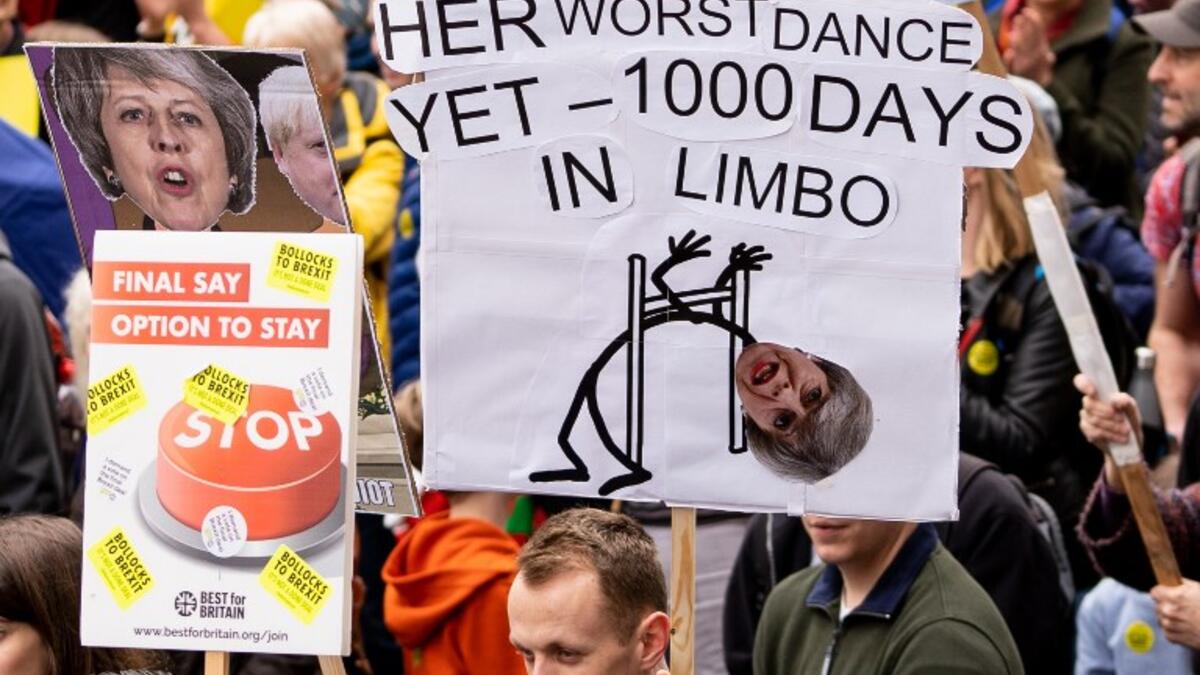 People hold up placards as they attend a march and rally organised by the pro-European People's Vote campaign for a second referendum in central London on March 23, 2019. 
Niklas HALLE'N / AFP