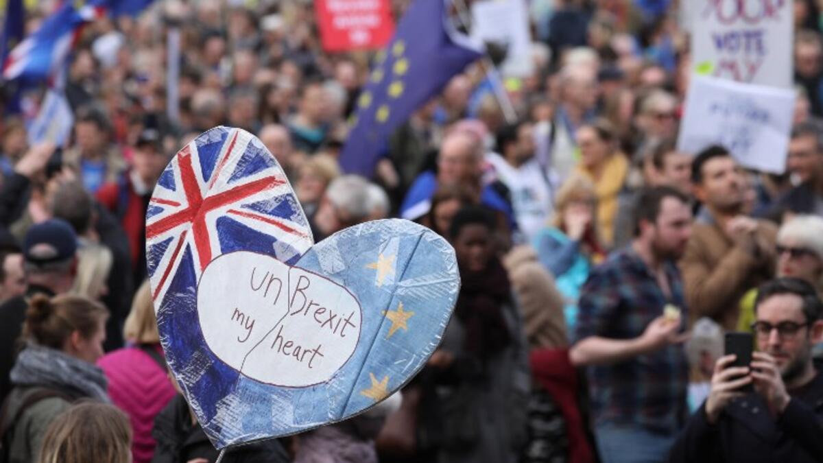People hold up placards and European flags as they attend a march and rally organised by the pro-European People's Vote campaign for a second referendum in central London on March 23, 2019.
Isabel INFANTES / AFP