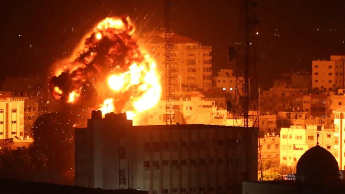 A ball of fire billows above buildings in Gaza City during reported Israeli strikes on March 25, 2019. Israel's military launched strikes on Hamas targets in the Gaza Strip today, the army and witnesses said, hours after a rocket from the Palestinian enclave hit a house and wounded seven Israelis.
Majdi Fathi / AFP