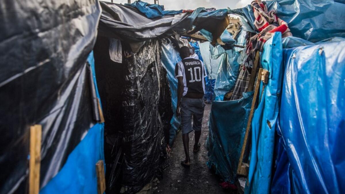 A sub-Saharan migrant walks between make-shift tents in the Oulad Ziane migrant camp in Casablanca on March 27, 2019. 
FADEL SENNA / AFP