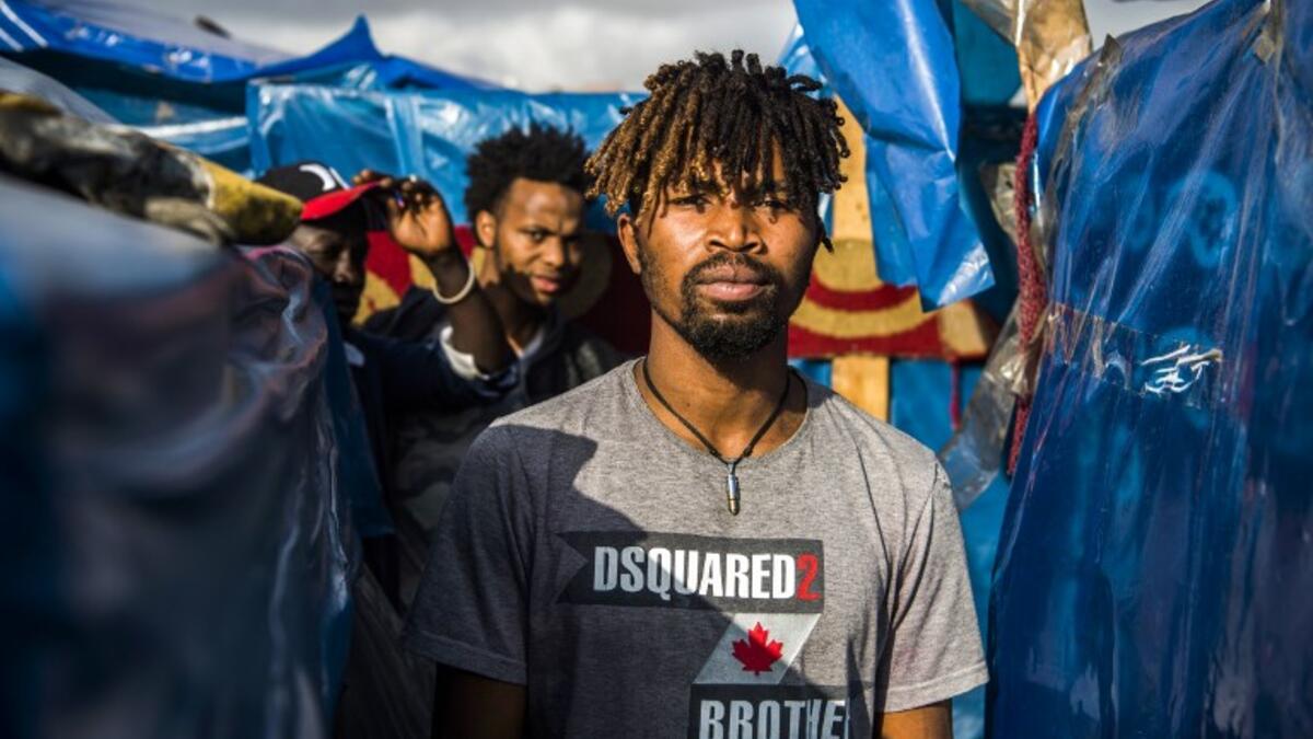 A sub-Saharan migrant walks between make-shift tents in the Oulad Ziane migrant camp in Casablanca on March 27, 2019. 
FADEL SENNA / AFP