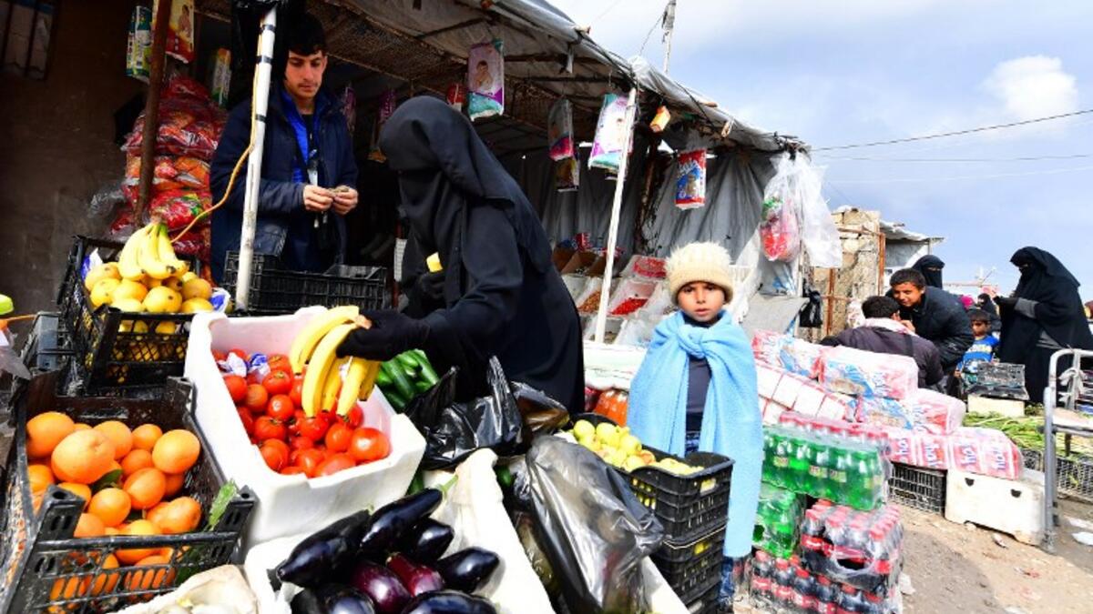 Displaced women buy vegetables and fruits in the souk or market of Al-Hol camp for displaced people in northeastern Syria
GIUSEPPE CACACE / AFP
