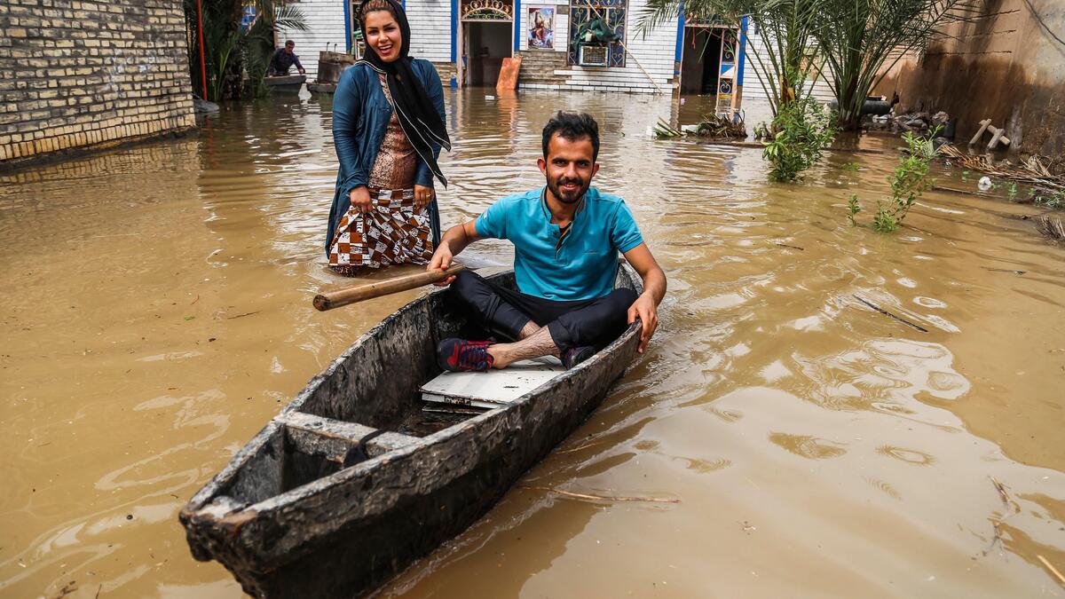 An Iranian man sits in a boat at his flooded garden in a village around the city of Ahvaz, in Iran's Khuzestan province. 
Mehdi PEDRAMKHOO / TASNIM NEWS / AFP