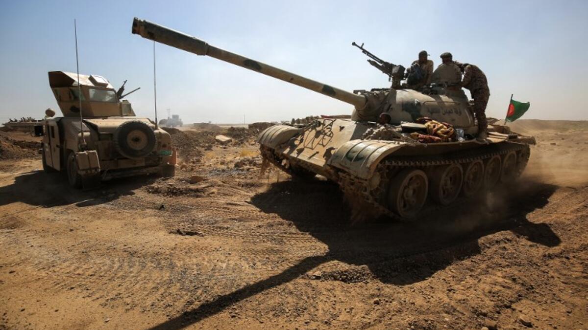 Tanks and vehicles of the combined Iraqi forces and Hashed al-Shaabi (Popular Mobilization) paramilitaries are seen on the advance towards villages between the northern Iraqi cities of Hawija and Kirkuk on October 6, 2017
AHMAD AL-RUBAYE / AFP