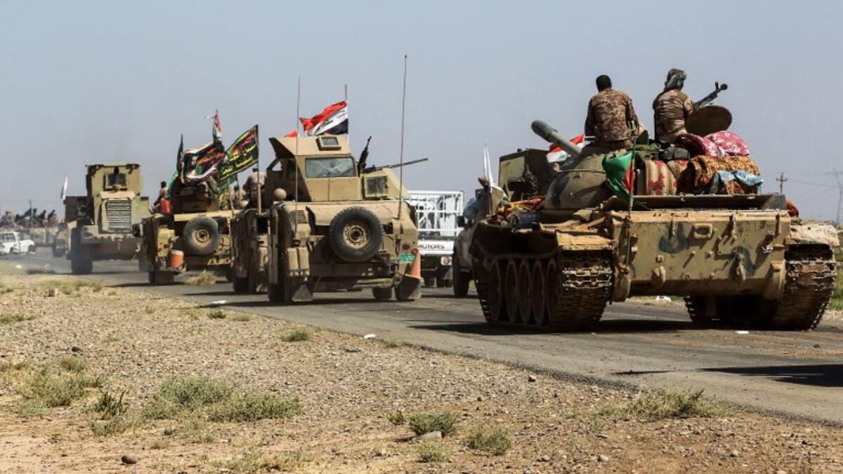 Tanks and vehicles of the combined Iraqi forces and Hashed al-Shaabi (Popular Mobilization) paramilitaries are seen on the advance towards villages between the northern Iraqi cities of Hawija and Kirkuk on October 6, 2017, after retaking Hawija from Islamic State (IS) group fighters a day before.
AHMAD AL-RUBAYE / AFP