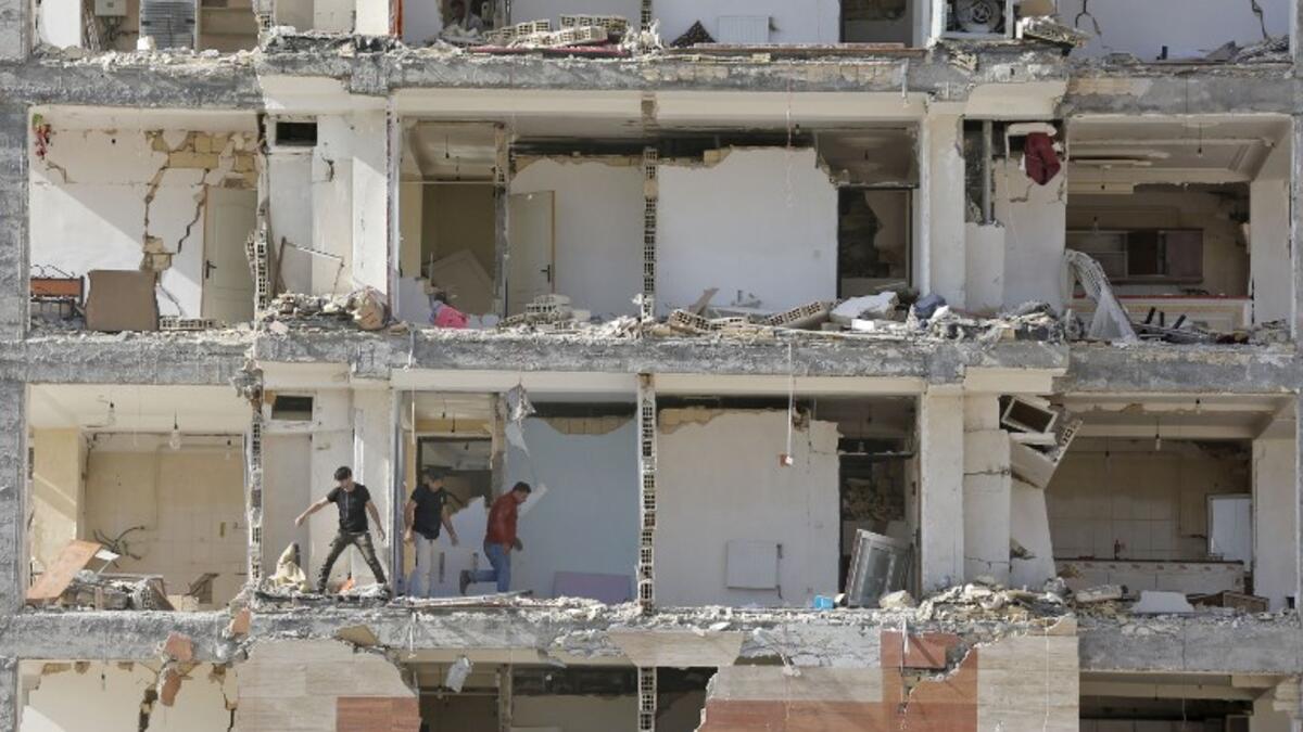 This picture shows a view through the buildings left damaged by the 7.3-magnitude earthquake that struck days before in the town of Sarpol-e Zahab in Iran's western Kermanshah province near the border with Iraq, leaving hundreds killed and thousands homeless. 

(ATTA KENARE / AFP)