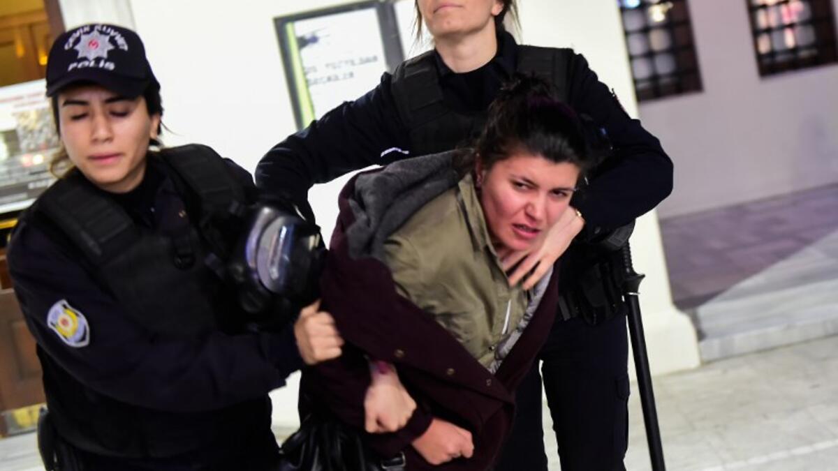 Turkish anti-riot police officers detain a leftist protester during a demonstration against the US and Israel on Dec. 9, 2017 in the Kadikoy district of Istanbul. Turkish President Recep Tayyip Erdogan described Israel as a "state of occupation" which used "terror" against the Palestinians.
(YASIN AKGUL / AFP)