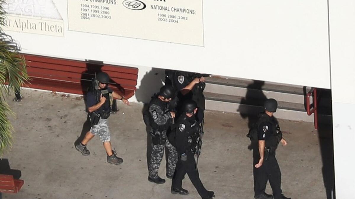 Law enforcement personel work the scene at the Marjory Stoneman Douglas High School after a shooting at the school that reportedly killed and injured multiple people on Feb. 14, 2018 in Parkland, Florida. Numerous law enforcement officials continue to investigate the scene. (Joe Raedle/Getty Images/AFP)
