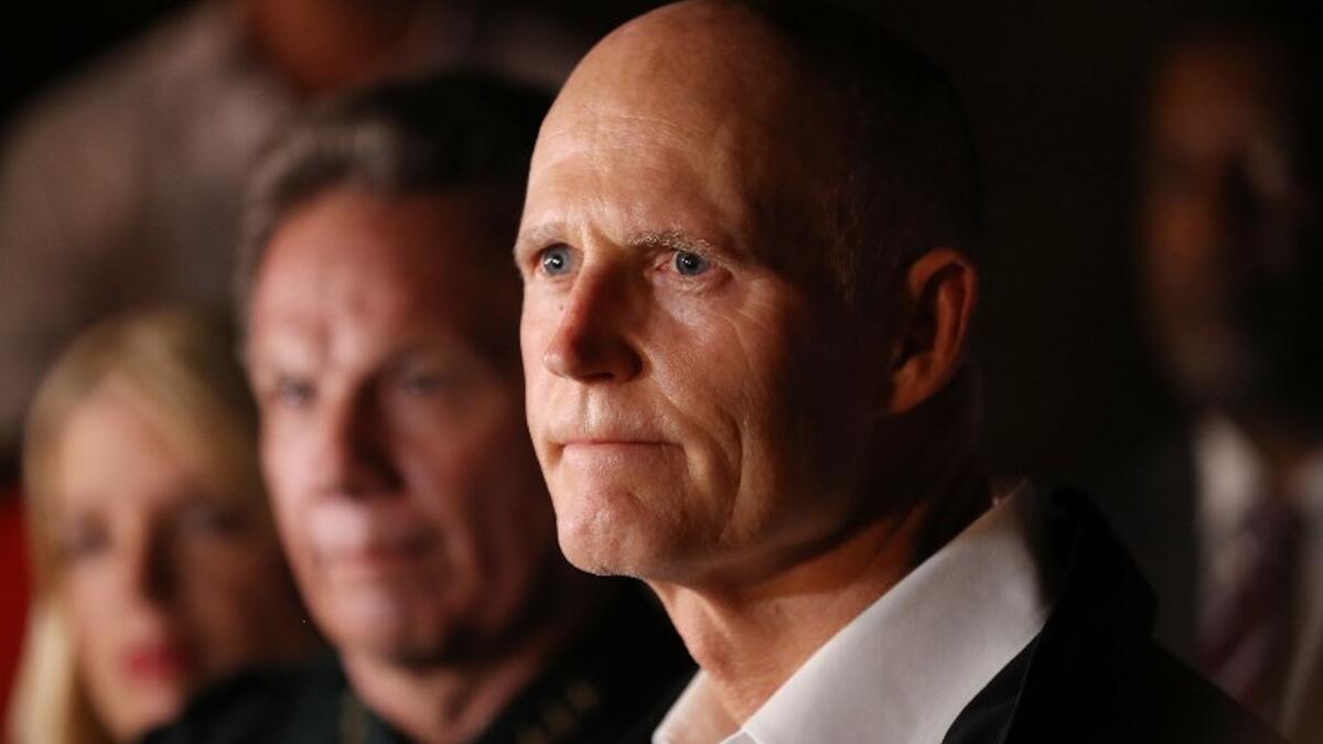 Florida Governor Rick Scott speaks to the media as he visits Marjory Stoneman Douglas High School after a shooting at the school killed 17 people on Feb. 14, 2018 in Parkland, Florida. Numerous law enforcement officials continue to investigate the scene. 
(Joe Raedle/Getty Images/AFP )