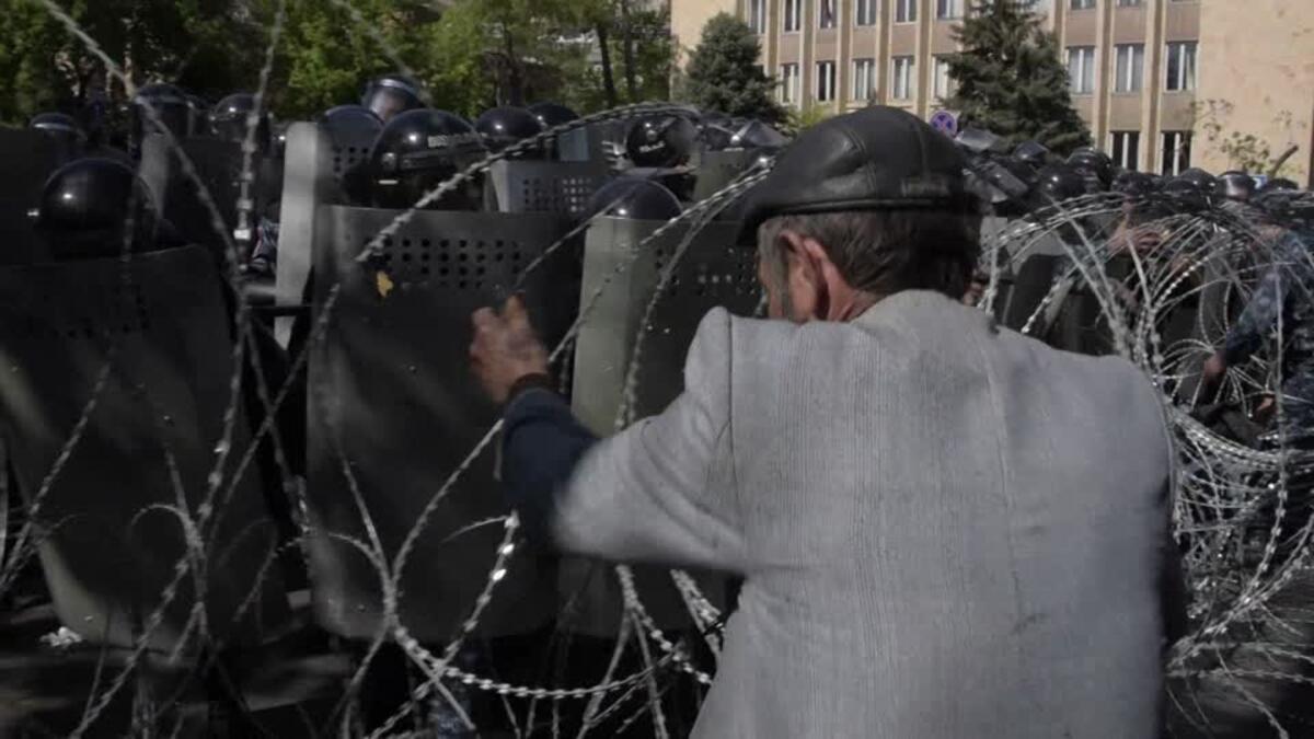 Hundreds of protesters tried to blockade the entrance to government headquarters before riot police intervened (AFP/File Photo)