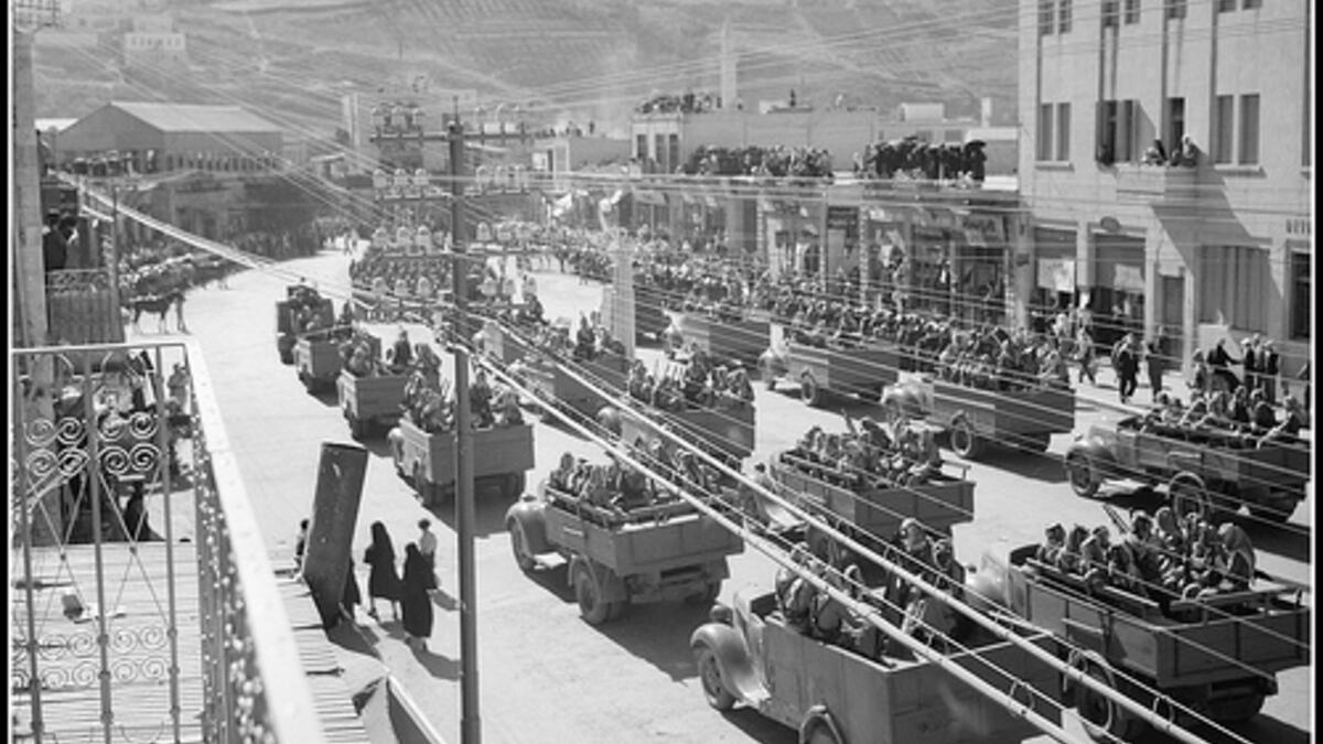 On the podium in the distant right of picture can be seen Emir Abdullah at a celebration in Amman, Jordan, of the 24th anniversary of Arab revolt - circa 1940. (flickriver.com)
