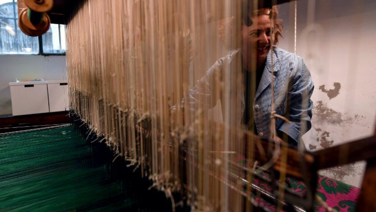 This picture  shows a woman at work in the laboratory of Antico setificio Fiorentino ancient silk factory in Florence. 
Tiziana FABI / AFP
