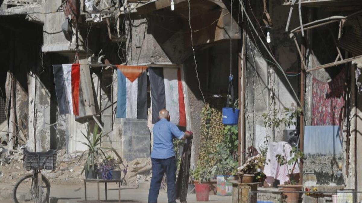A man stands in a street near destroyed buildings in the Palestinian camp of Yarmuk southern Damascus on November 1, 2018. 
LOUAI BESHARA / AFP