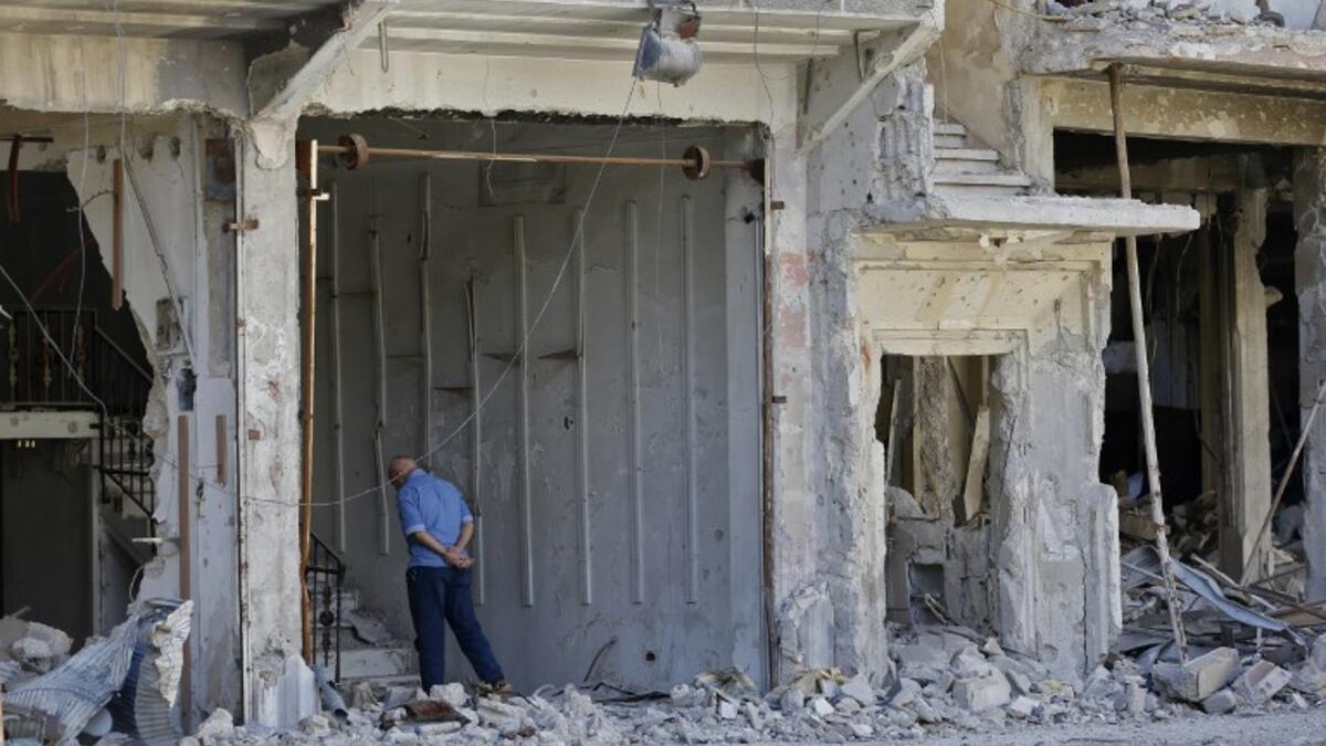 A man stands near a destroyed building in the Palestinian camp of Yarmuk southern Damascus on November 1, 2018. 
LOUAI BESHARA / AFP