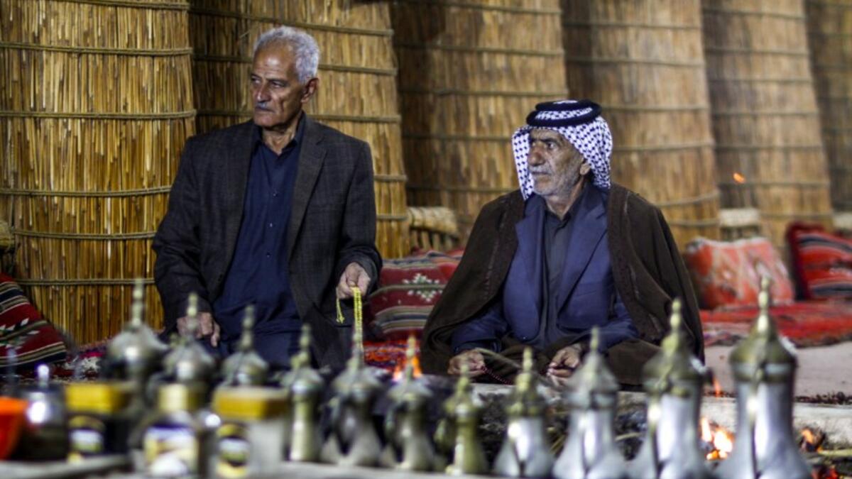 Members of an Iraqi clan gather inside a straw tent in the town of Mishkhab, south of Najaf on November 15, 2018. 
Haidar HAMDANI / AFP