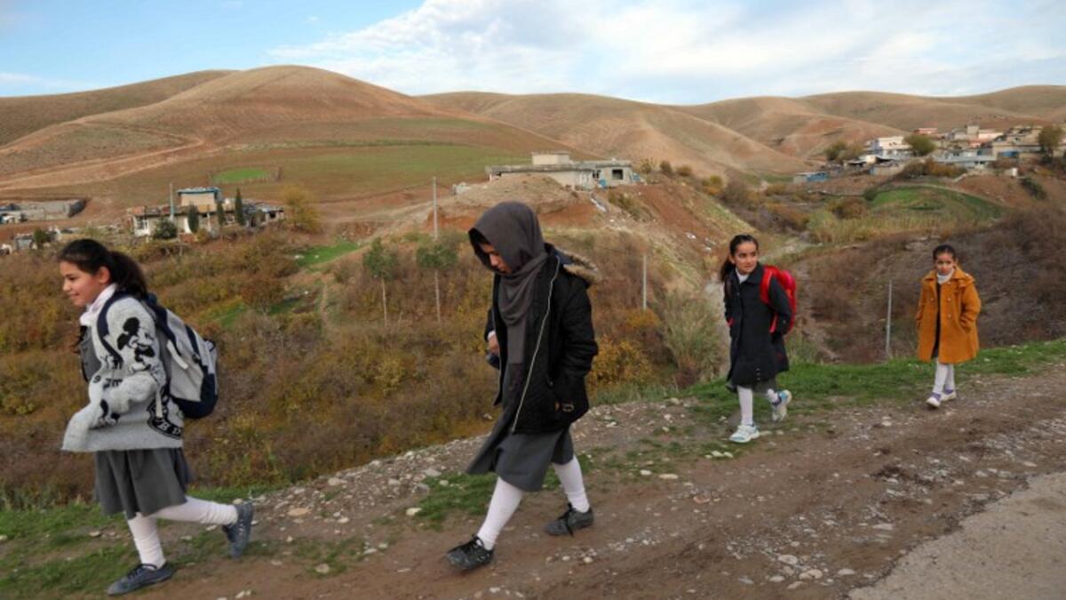 Young girls walk to school in Sharboty Saghira, a small village east of regional capital Arbil.
SAFIN HAMED / AFP